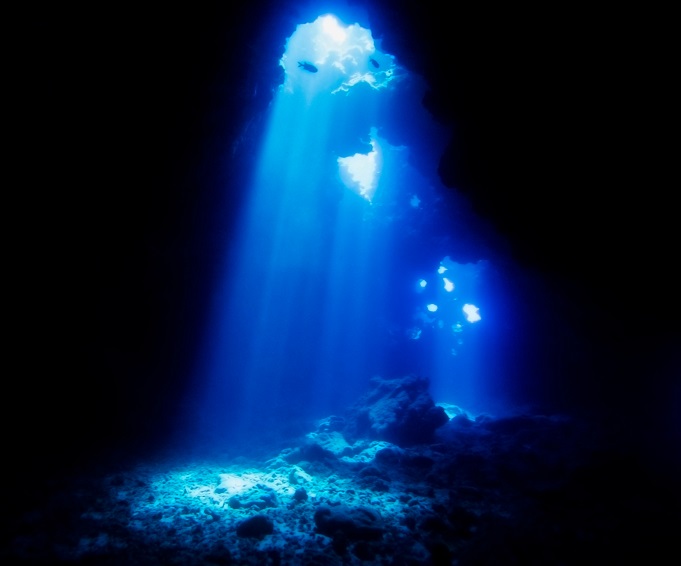 Cathedrals Dive Site Hawaii with Beams of Sunlight Entering Lava